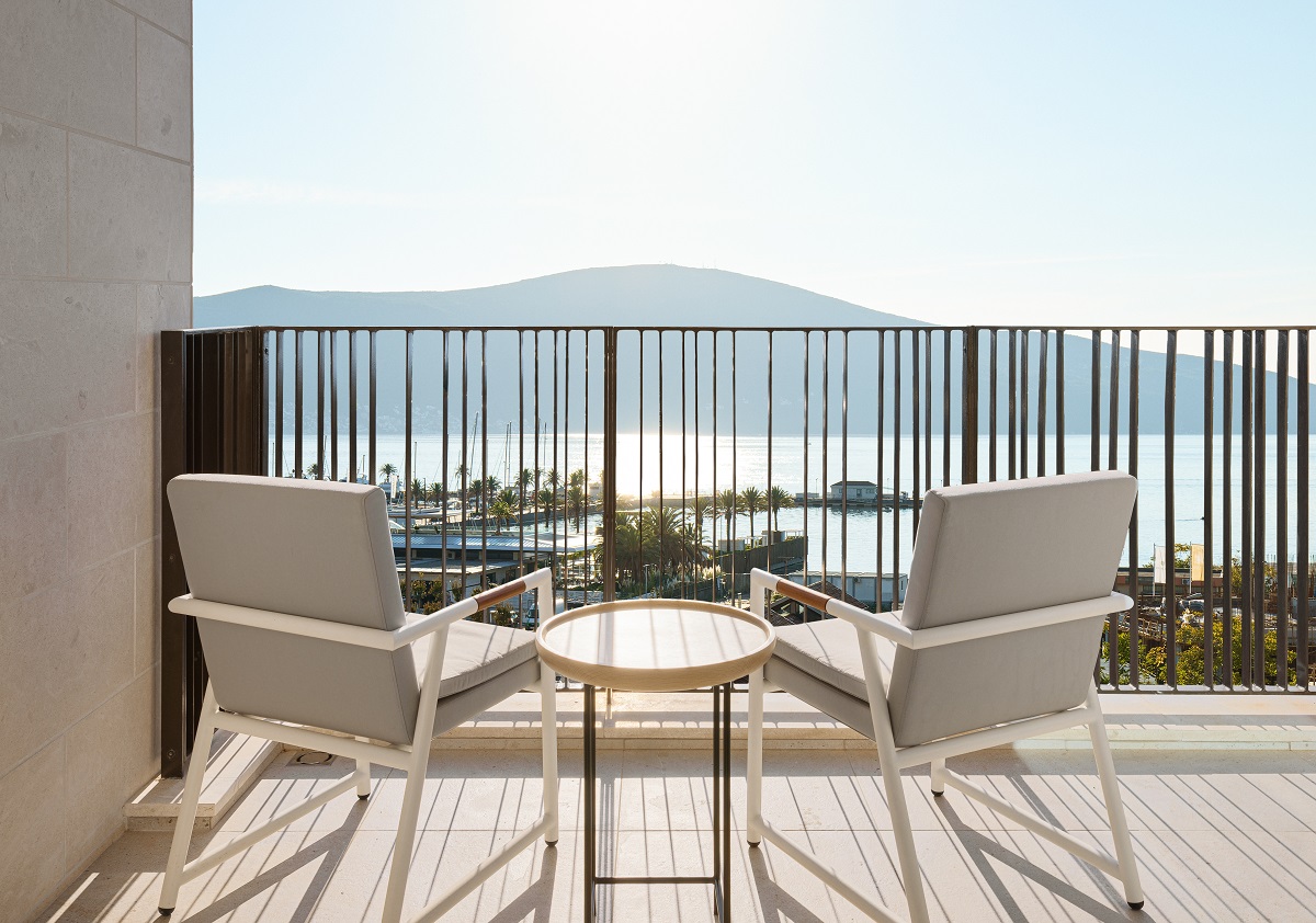 chairs and a table on veranda with views of the bay at SIRO Boka Place