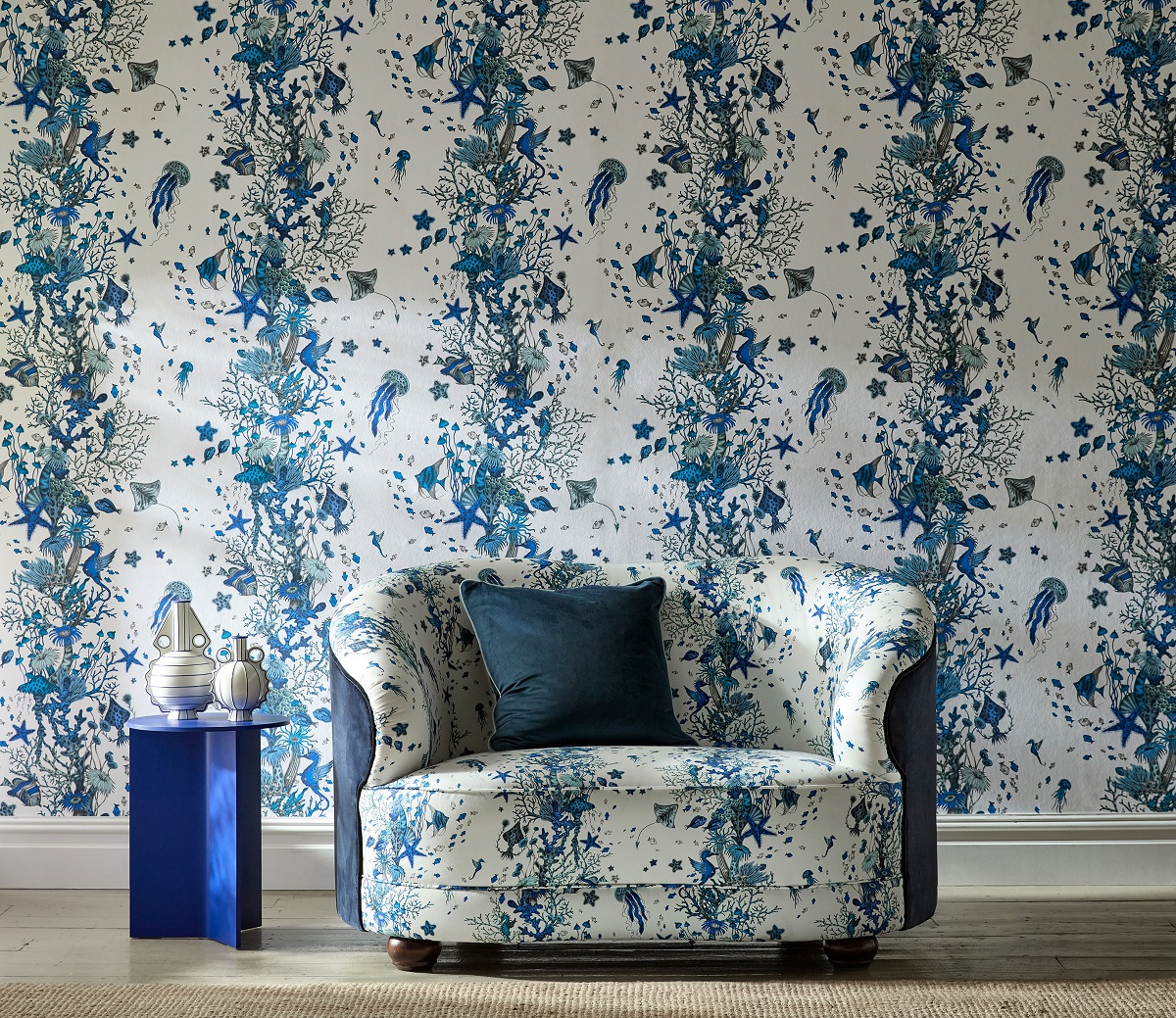 blue and white couch in front of blue and white wallpaper in same Seaforest design