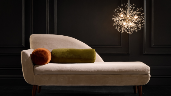 cream velvet couch under chandelier with velvet cushions