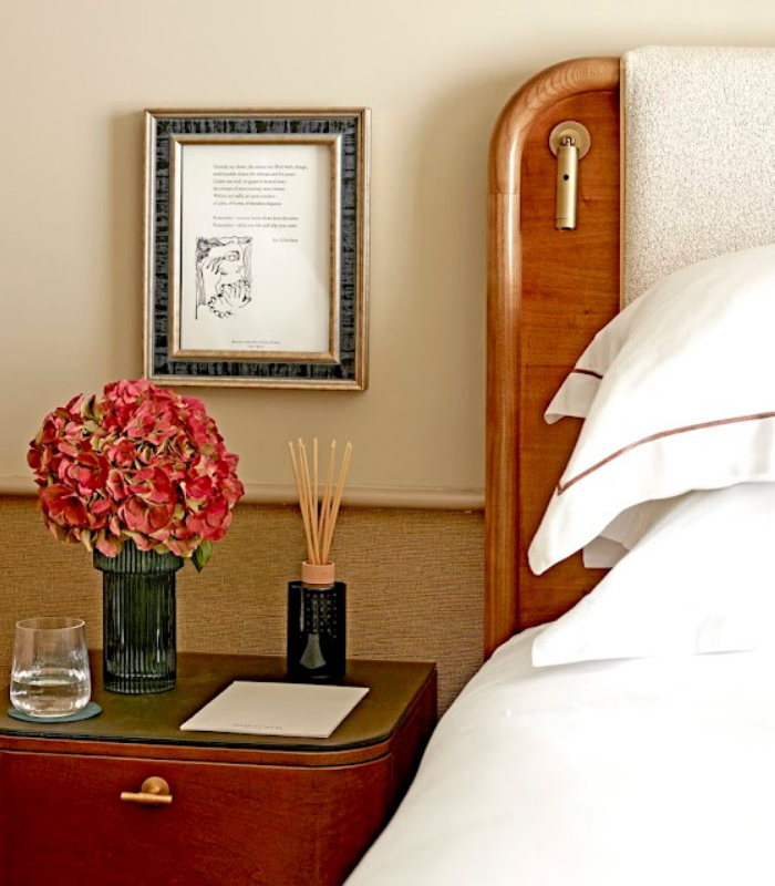 Close up image of bed, bedside table and poetry illustration artwork at the Montcalm Mayfair