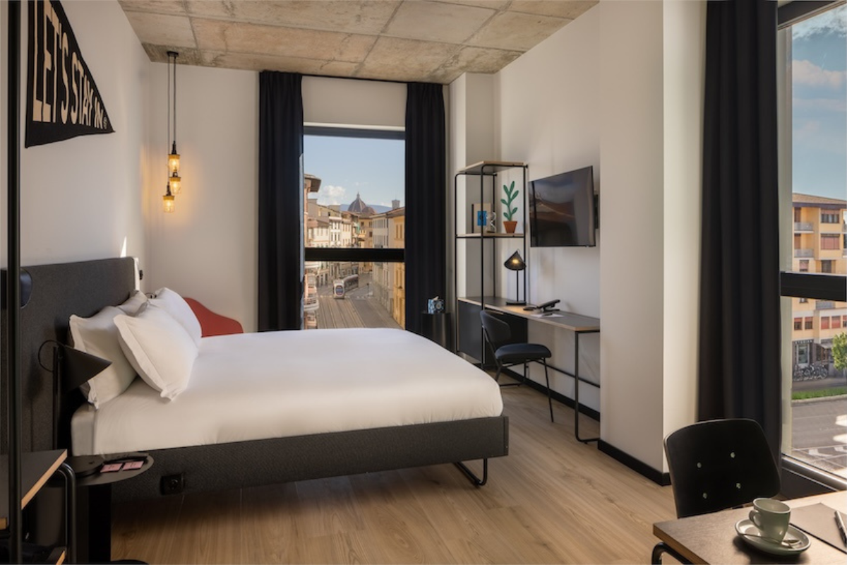 The Social Hub Florence Belfiore guest suite, overlooking Florence city. A 2025 hotel opening