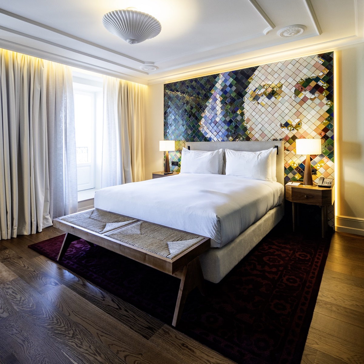 hand made tiles create a mural behind the bed in Hotel DUO Boavista designed by S+A