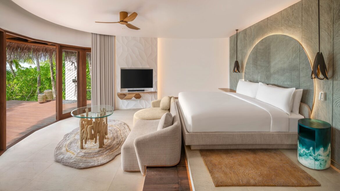 white and natural bedroom design in beach villa with driftwood table W Maldives