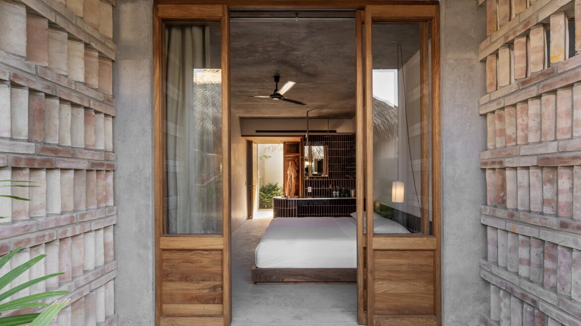 view through into guestroom at Hotel Humano with raw concrete and wood surfaces