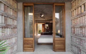 view through into guestroom at Hotel Humano with raw concrete and wood surfaces