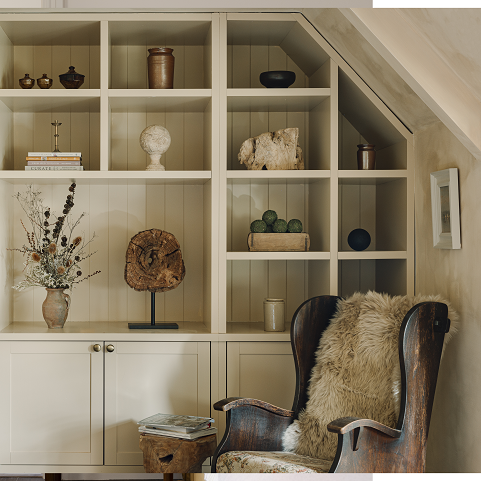 vintage wooden chair in front of cream bookcase