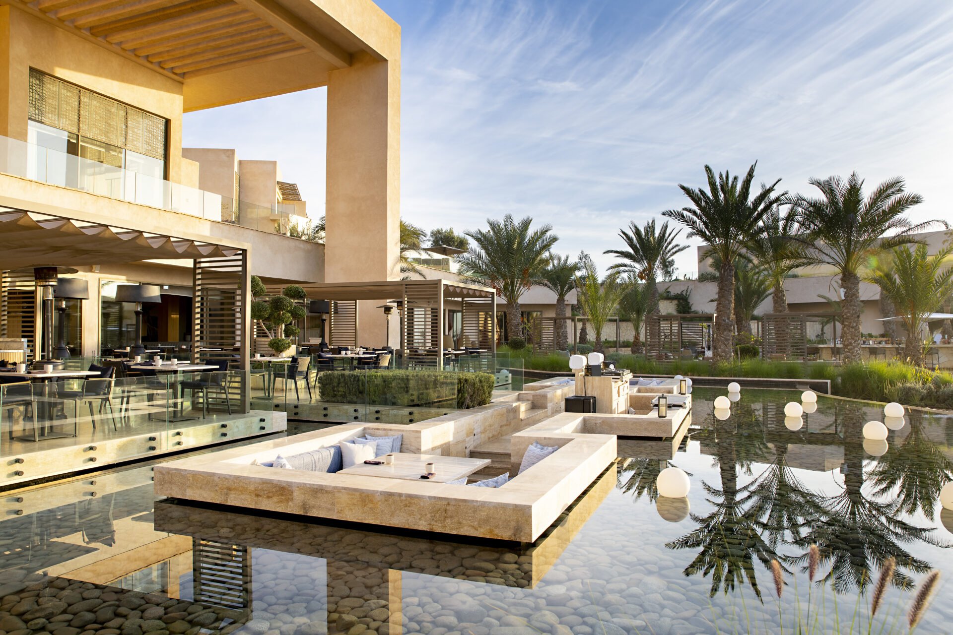 Fairmont Tagazhout pool area surrounded by palms 