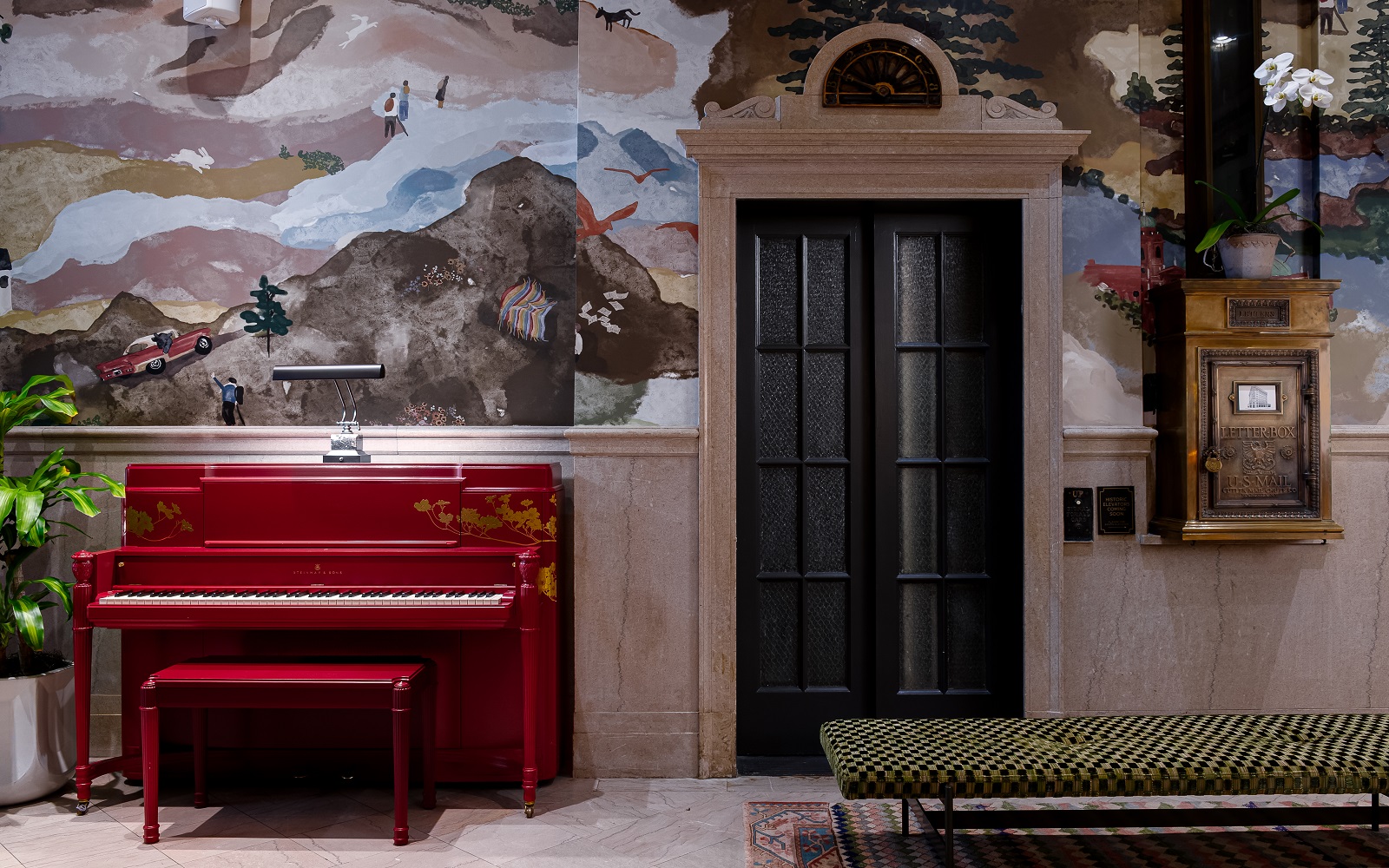 red piano and hand painted wallpaper in the lobby of Asheville Flat Iron Hotel