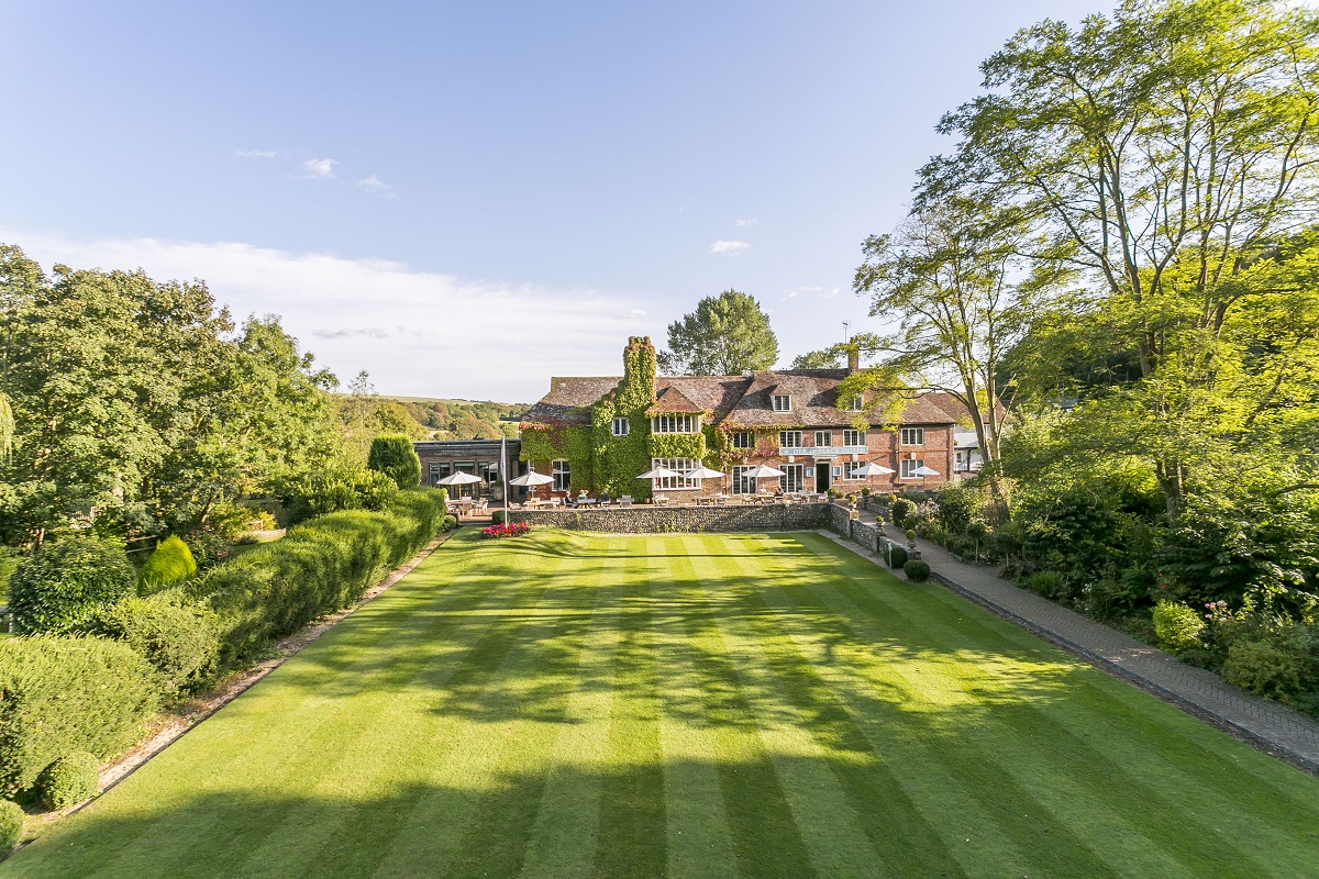 croquet lawn in front of the terrace and main building at The Afriston hotel in The Signet Collection