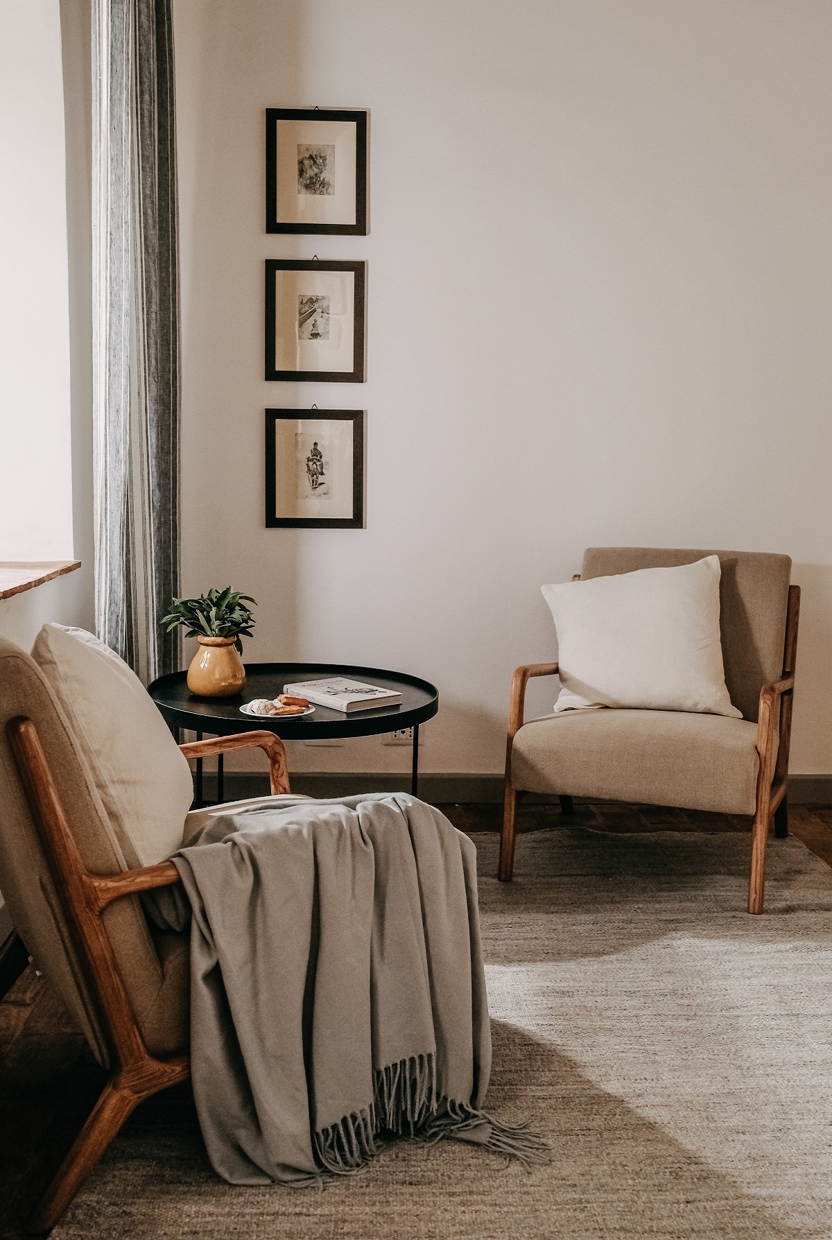 chairs with natural linen throw over the arm in front of window