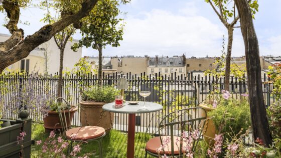 bistrot chairs and a glass of wine on the roof terrace in Parisian hotel La Fantaisie