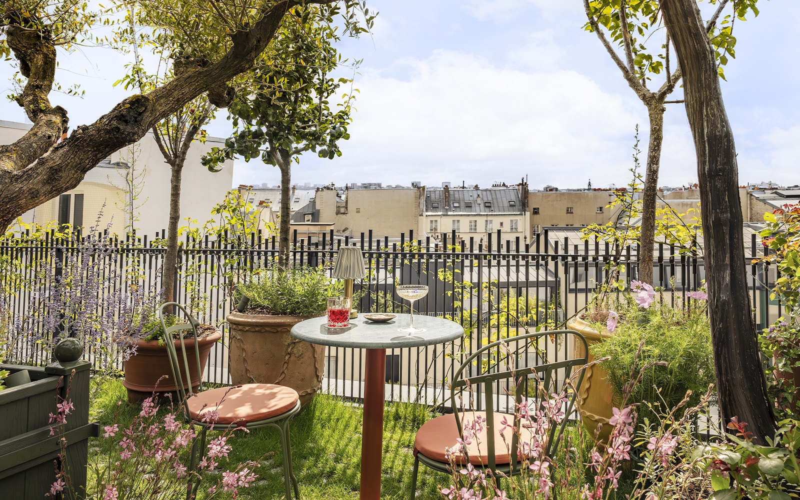 bistrot chairs and a glass of wine on the roof terrace in Parisian hotel La Fantaisie