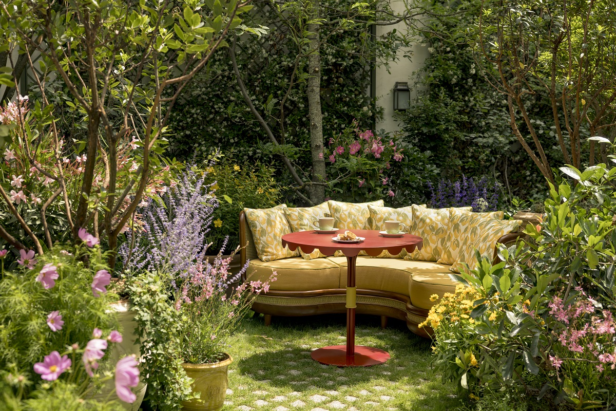 yellow striped couch and orange table in garden in paris