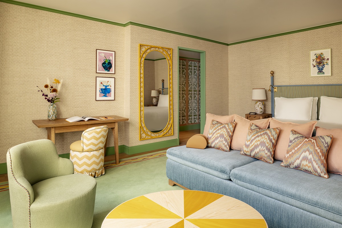 yellow table, green chair and blue couch in guestroom