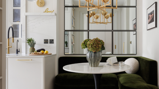 white marble table top with mirrored wall behind and dark seating surround. Liang & Eimil surfaces