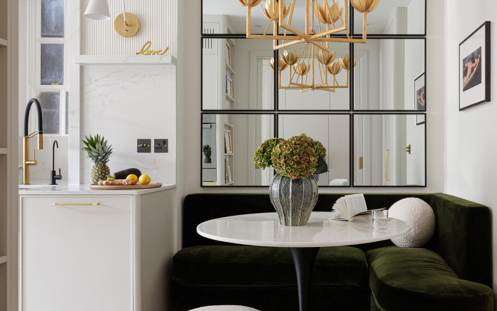 white marble table top with mirrored wall behind and dark seating surround. Liang & Eimil surfaces