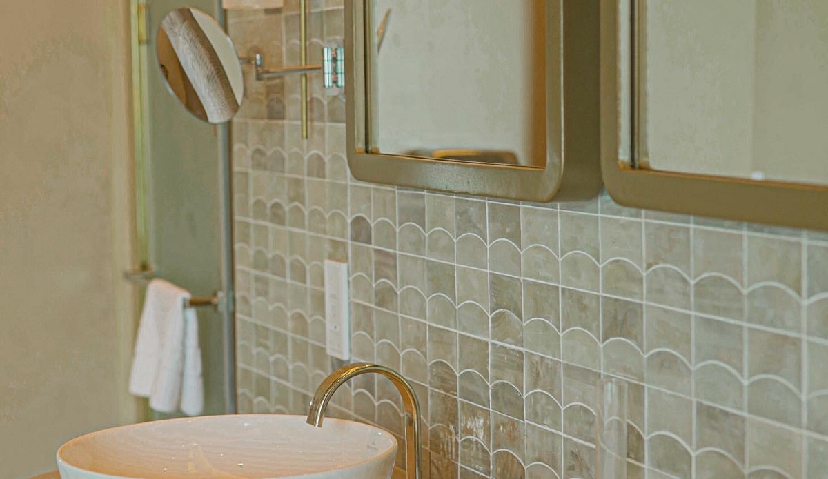 detail of textured tile behind basin in hotel bathroom