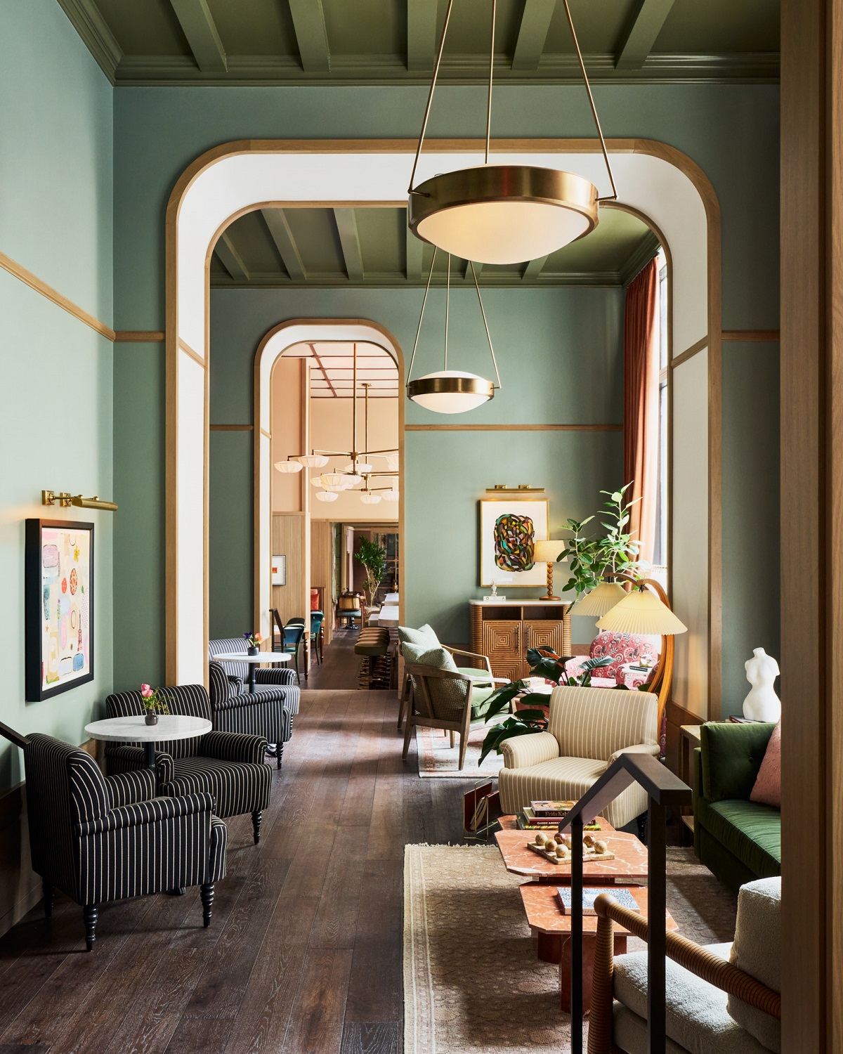 green walls with square arches leading from lobby to club room in Fidelity Hotel