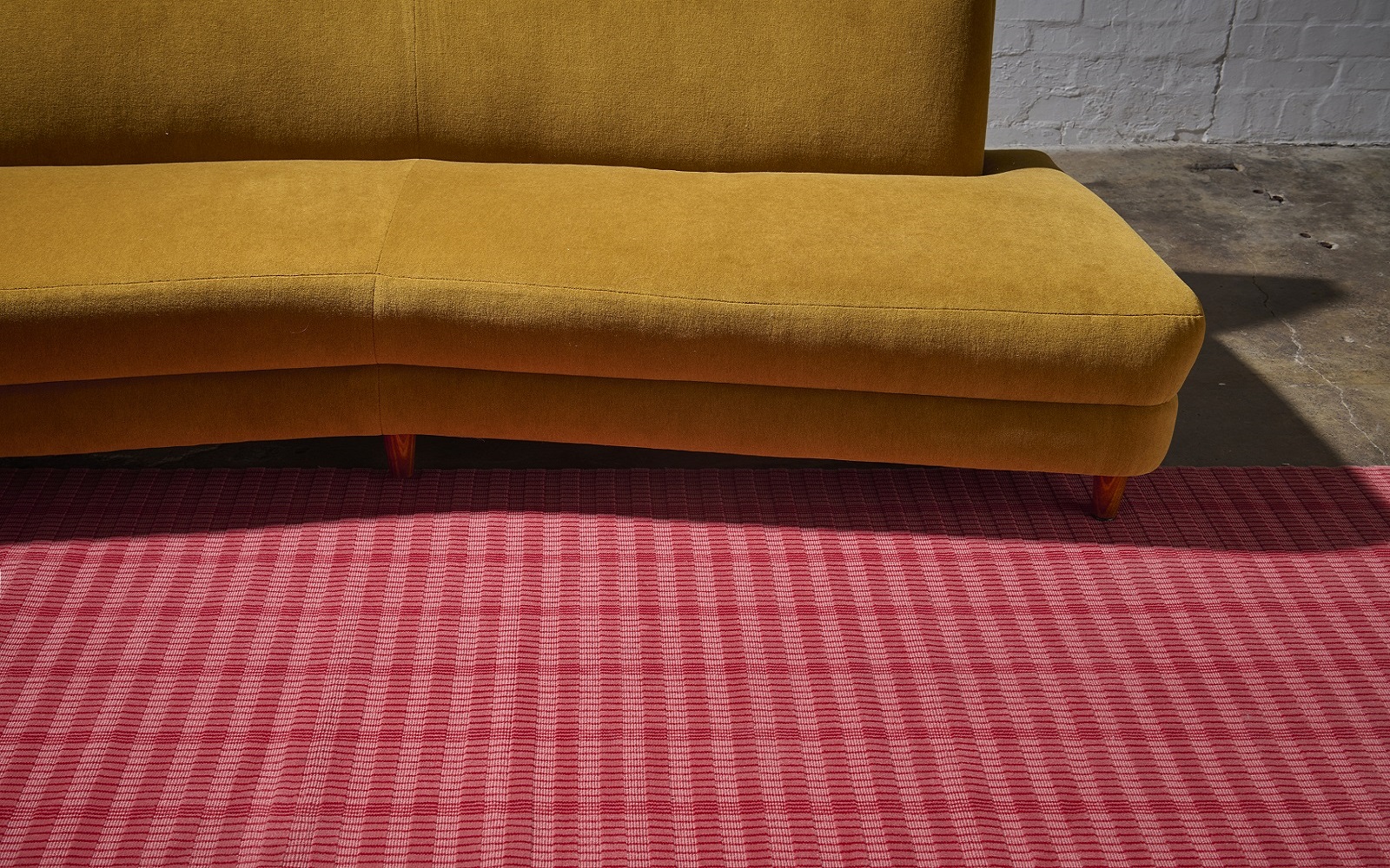 mustard sofa on red Modieus carpet