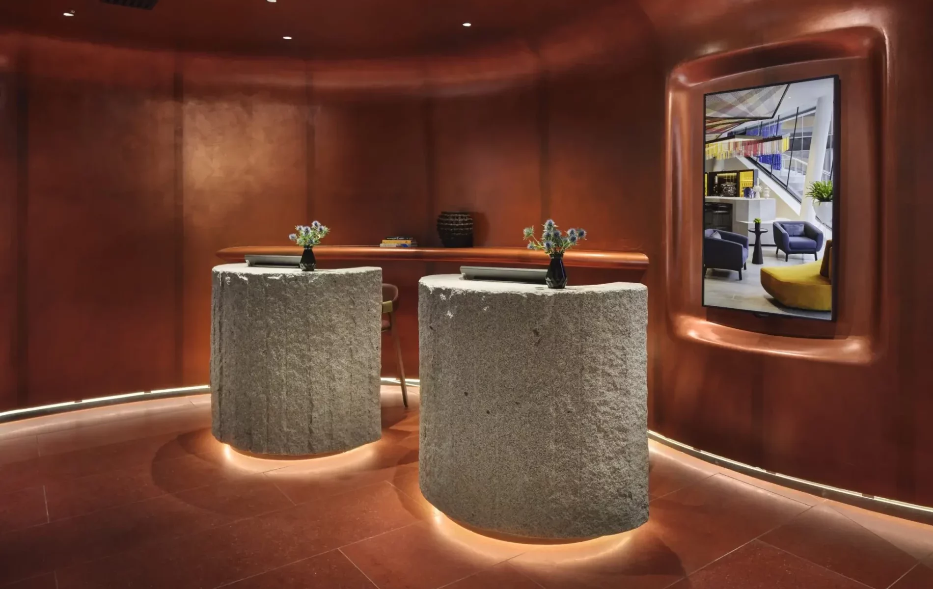 two rock surfaced desks in bronze hotel lobby