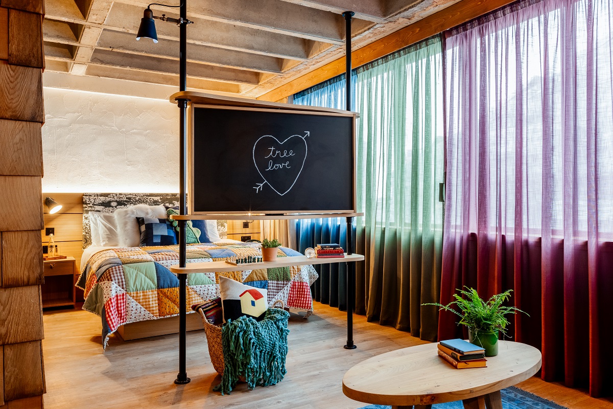 patchwork bed cover and wooden surfaces in studio suite in Treehouse Hotel Manchester