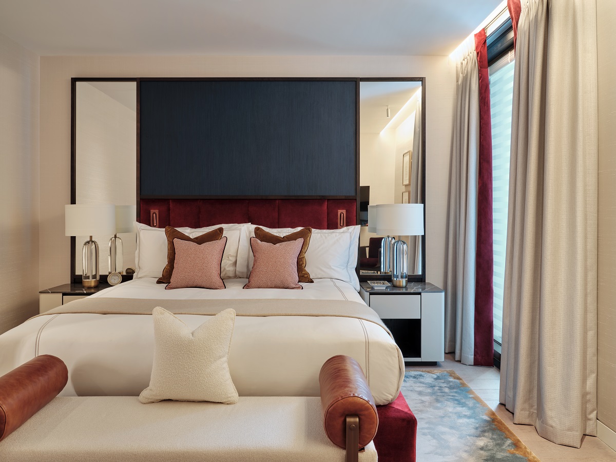 white couch and bed with brown and blue accents in Mandarin Oriental Mayfair Residences