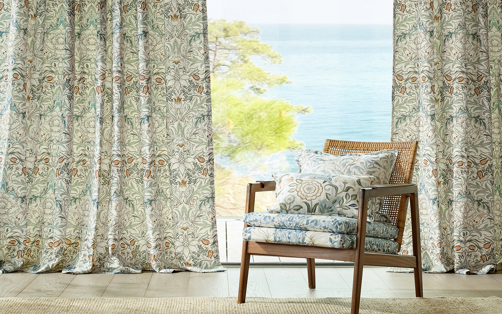 chair in william morris fabric in front of curtains and sea view