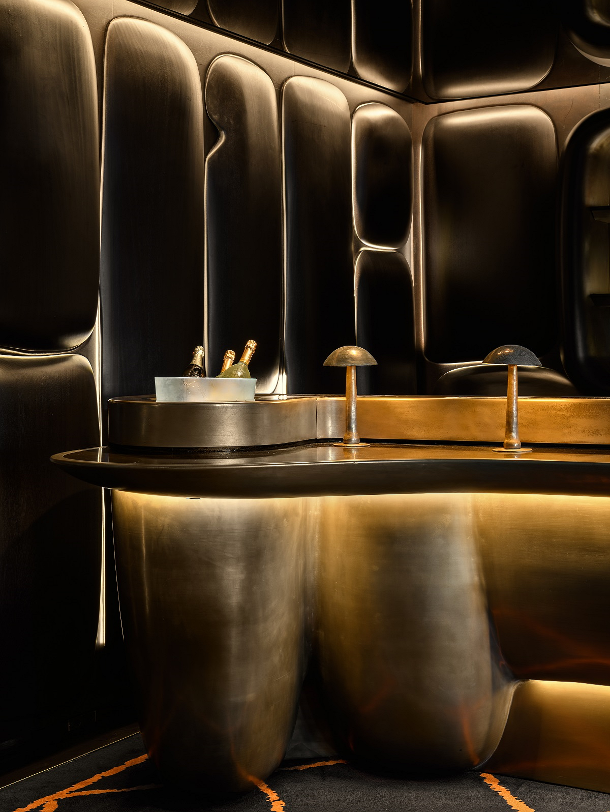 curved gold bar in the redesigned Canvas Bar by Küchel Architects for Dolder grand