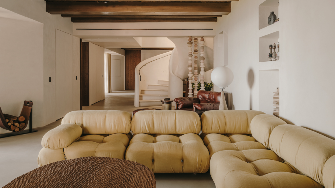 deep buttoned couch and wooden table in public area of a Highstay luxury apartment