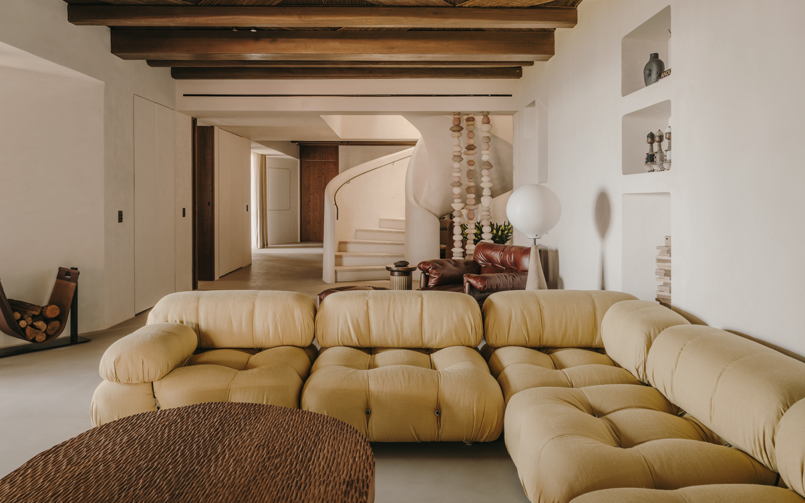 deep buttoned couch and wooden table in public area of a Highstay luxury apartment