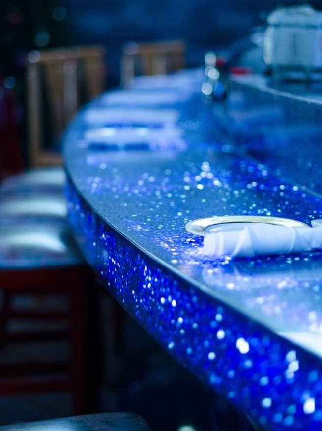 curved bar counter surface in blue engineered terrazzo