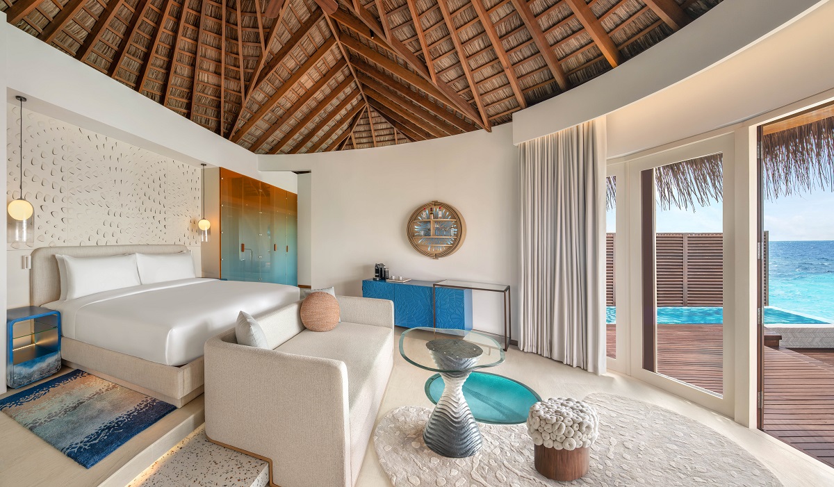 reed ceiling, white furniture and blue accessories in overwater villa W Maldives