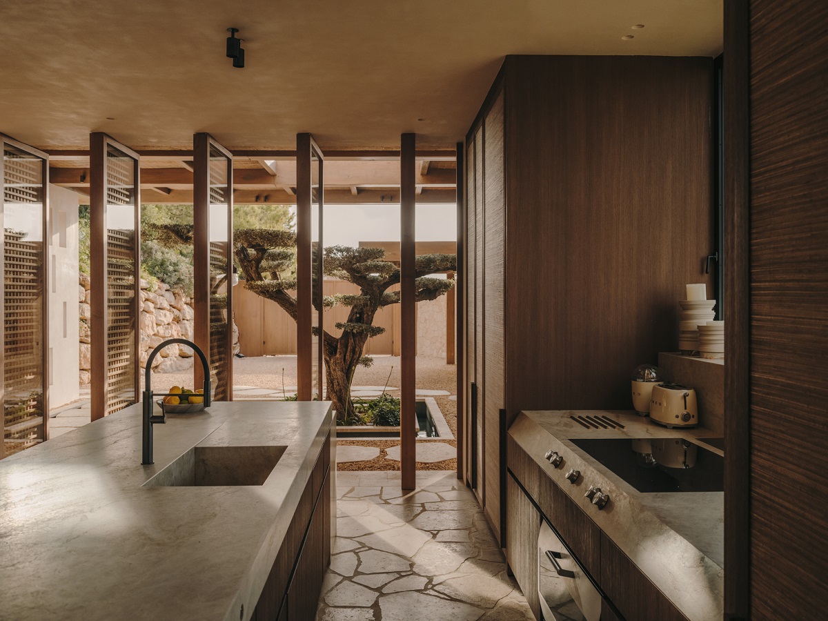 stone surfaces in the kitchen with view onto courtyard with olive tree