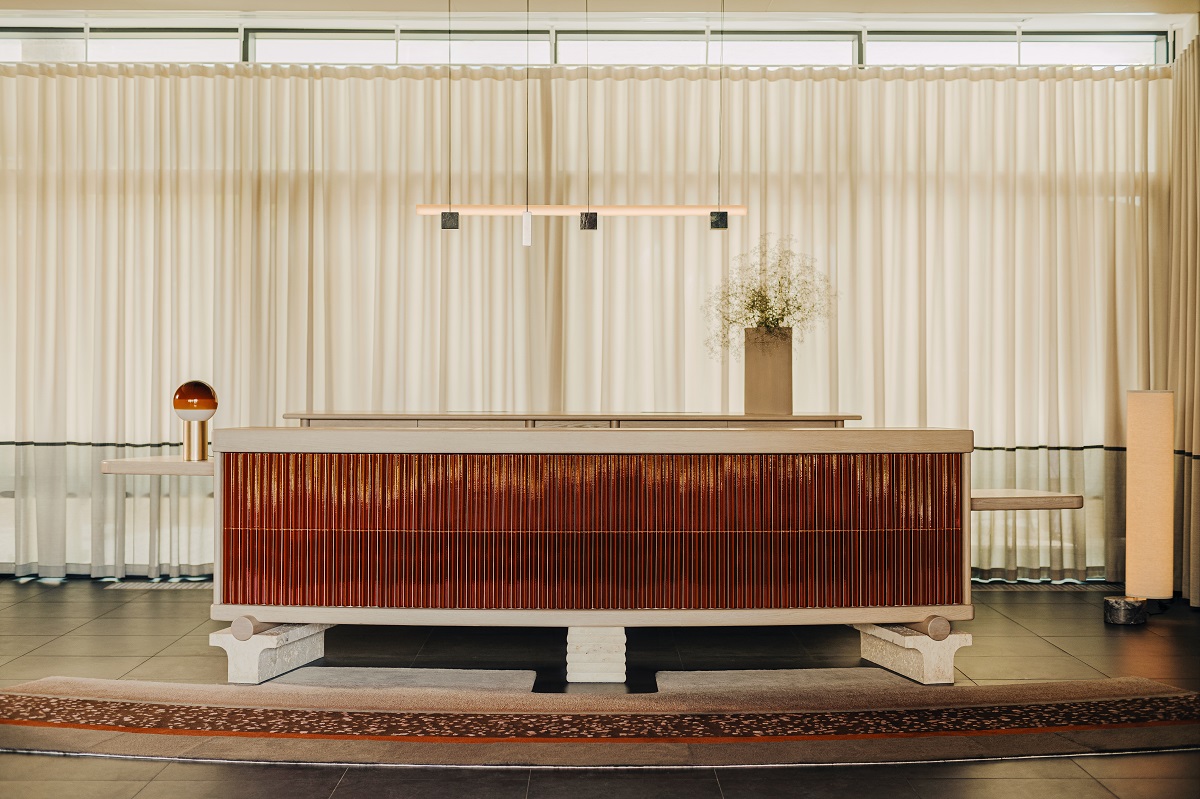 reception desk with red tiled front in PURO Poznan designed by Holloway Li