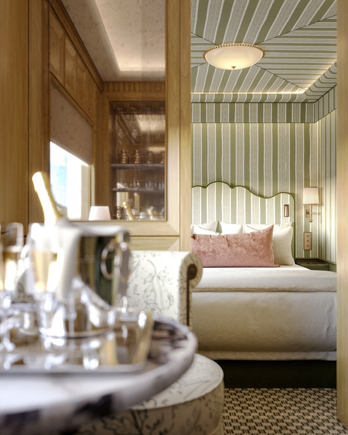 wine glasses on tray in foreground with luxury train suite behind