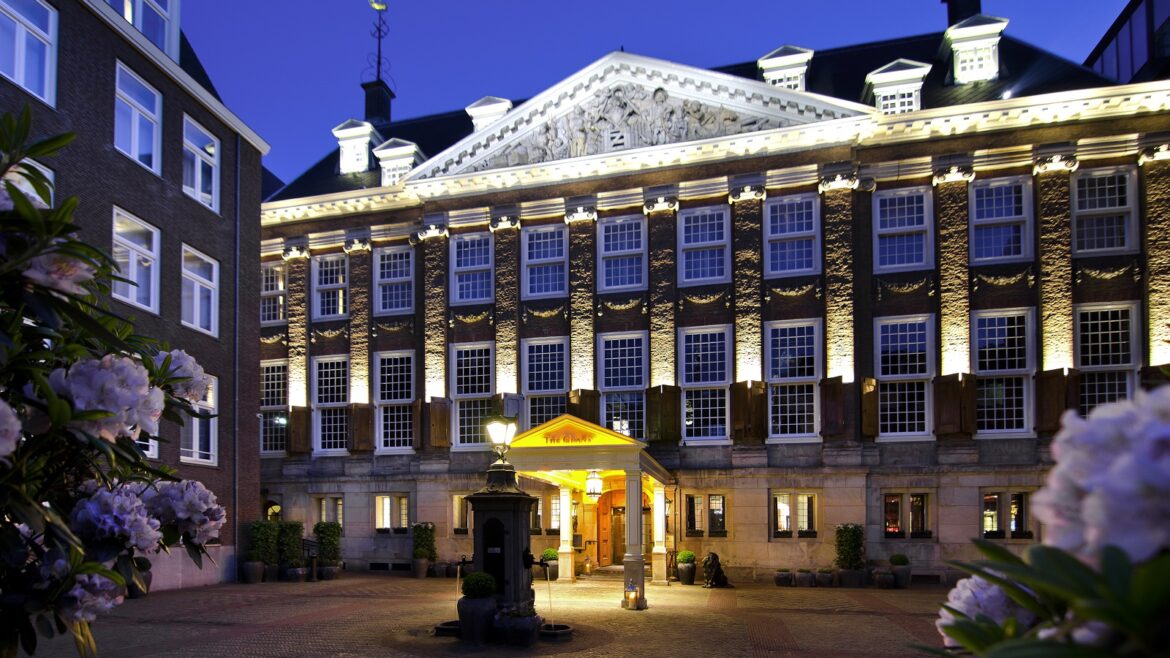 exterior period facade of Sofitel Legend The Grand Amsterdam lit up at night