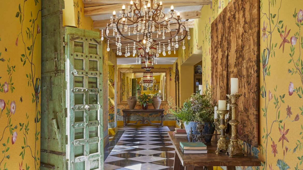 yellow patterned wallpaper, checked floor and chandelier in maximalist interior of Franschoek House Royal Portfolio