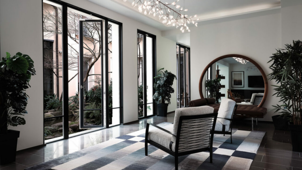 greyscale room with french doors overlooking courtyard with tree in centre