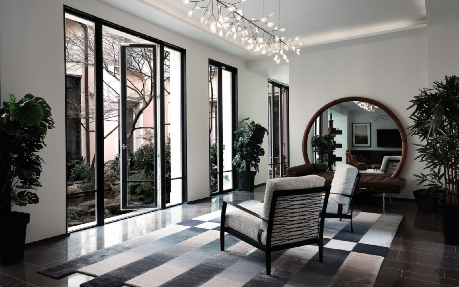 greyscale room with french doors overlooking courtyard with tree in centre