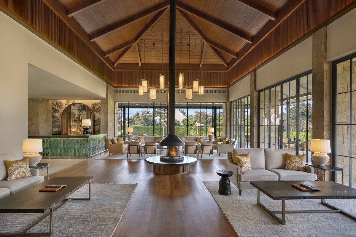 pitched wooden roof and floor to ceiling glass in the lounge of Oberoi wildlife resort