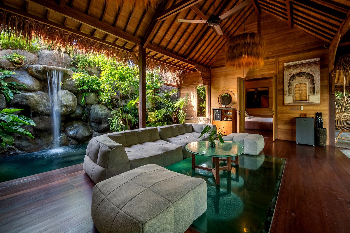 seating under bamboo roof in front of waterfall