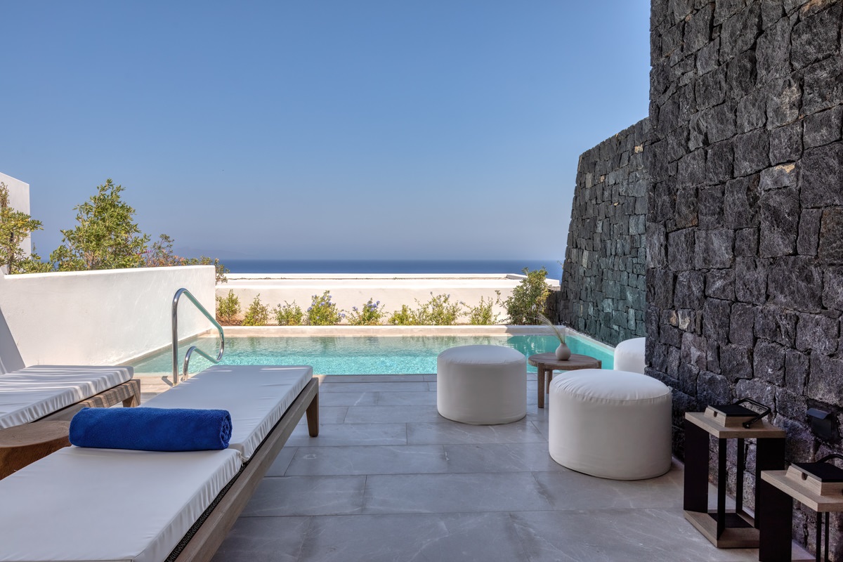 private pool outside sandblu maisonette with white walls and blue seaview