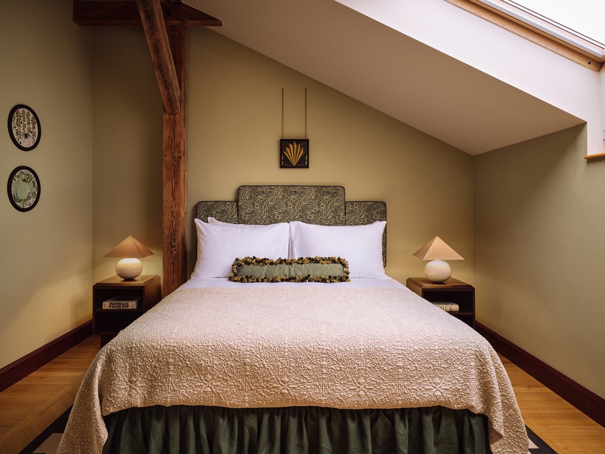 bedroom under the eaves with slanted ceiling and skylight in sir Prague