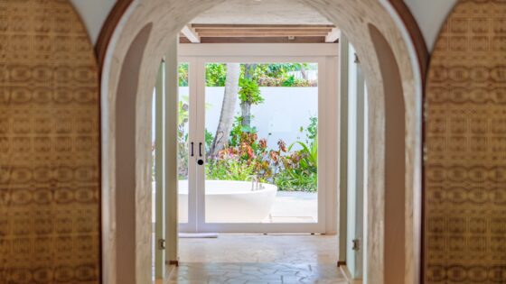 doors and arches leading from bedroom to outdoor bathroom at Sirru Fen Fushi