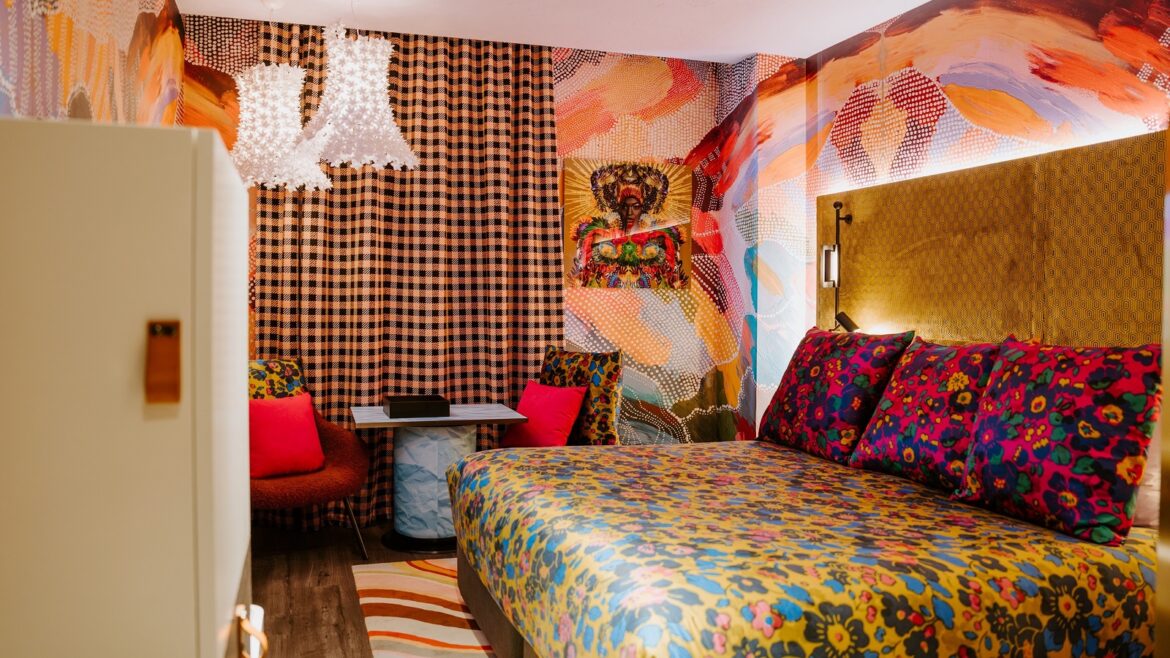 checked curtains, floral bedcover and pattern wallpaper in The-Motley-Hotel-Richmond-Tapestry-Collection-by-Hilton-Guest-Room