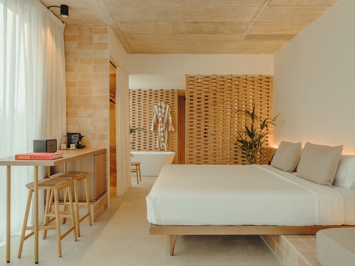 wooden screens, stone surfaces and plants in guestroom at Bonita Ibiza