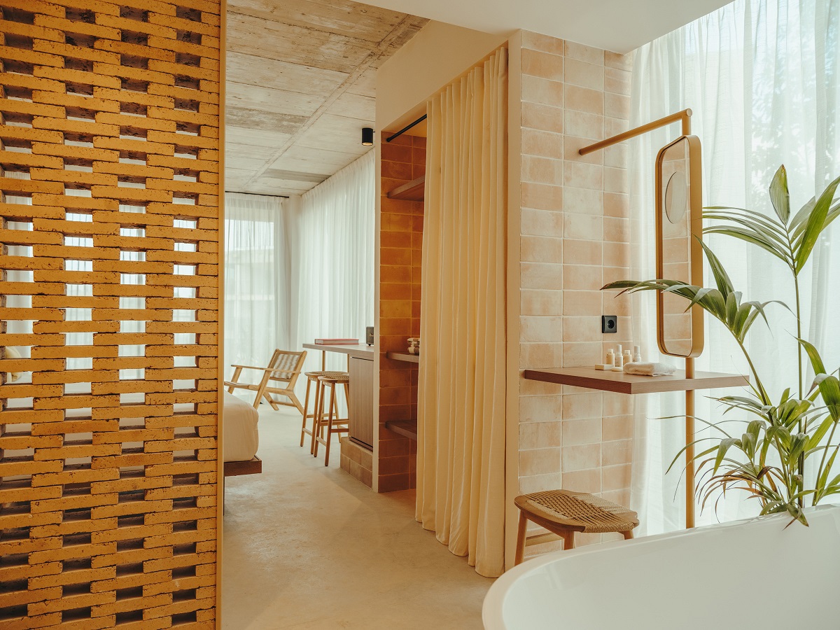 wooden screens, stone surfaces and plants in guestroom at Bonita Ibiza