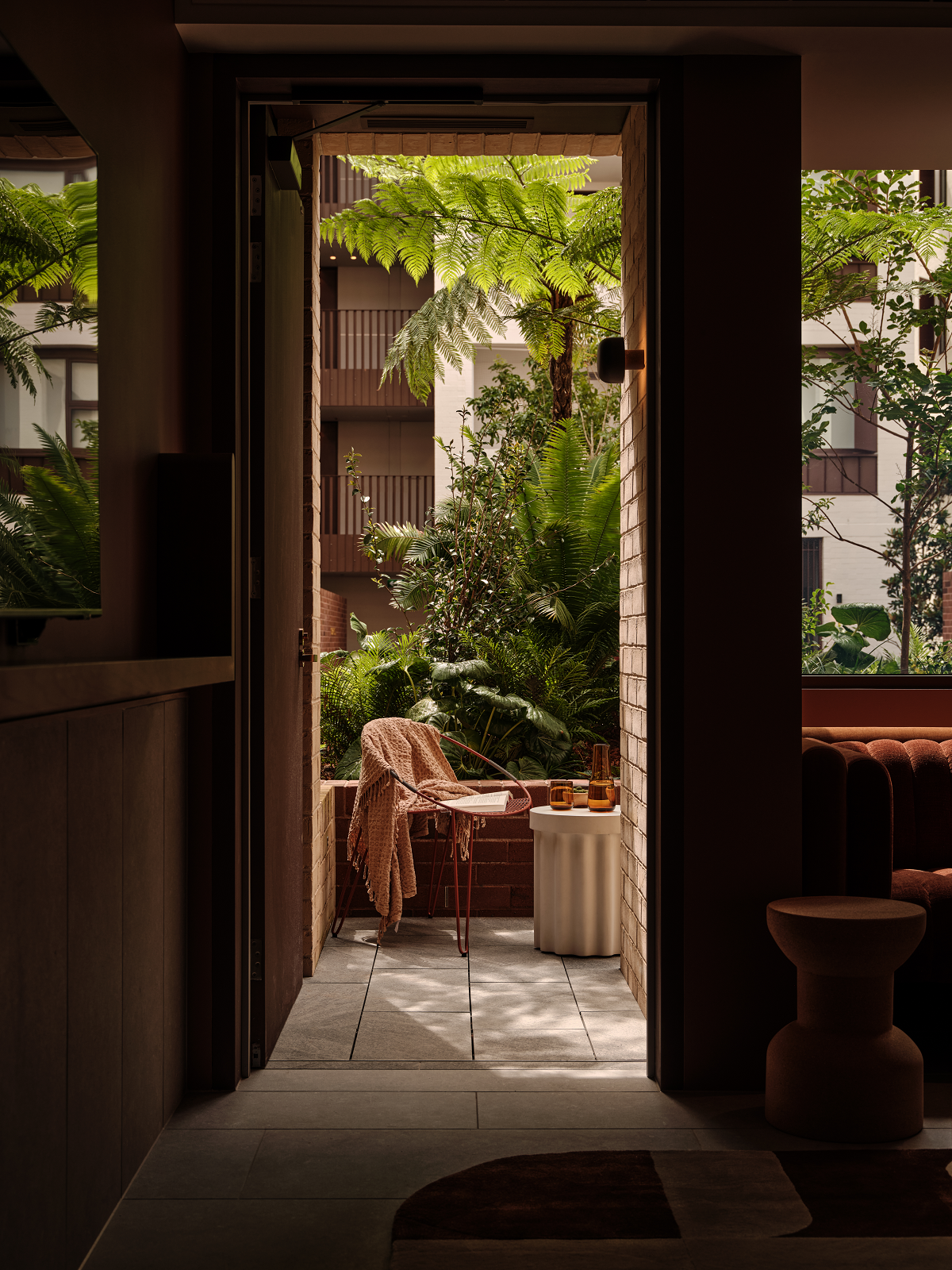 view from guestroom onto terrace and garden in The EVE Sydney