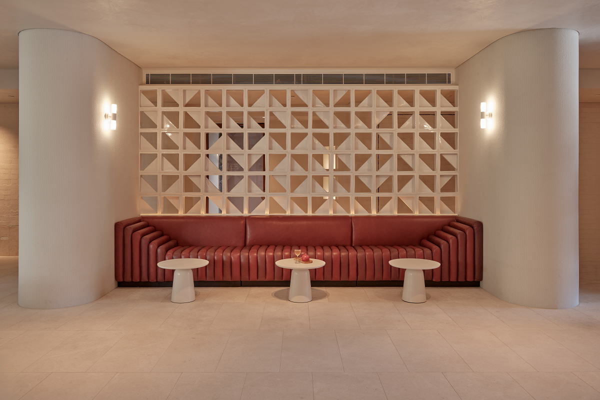 white walls and brown couch in minimalist lobby in The EVE Sydney