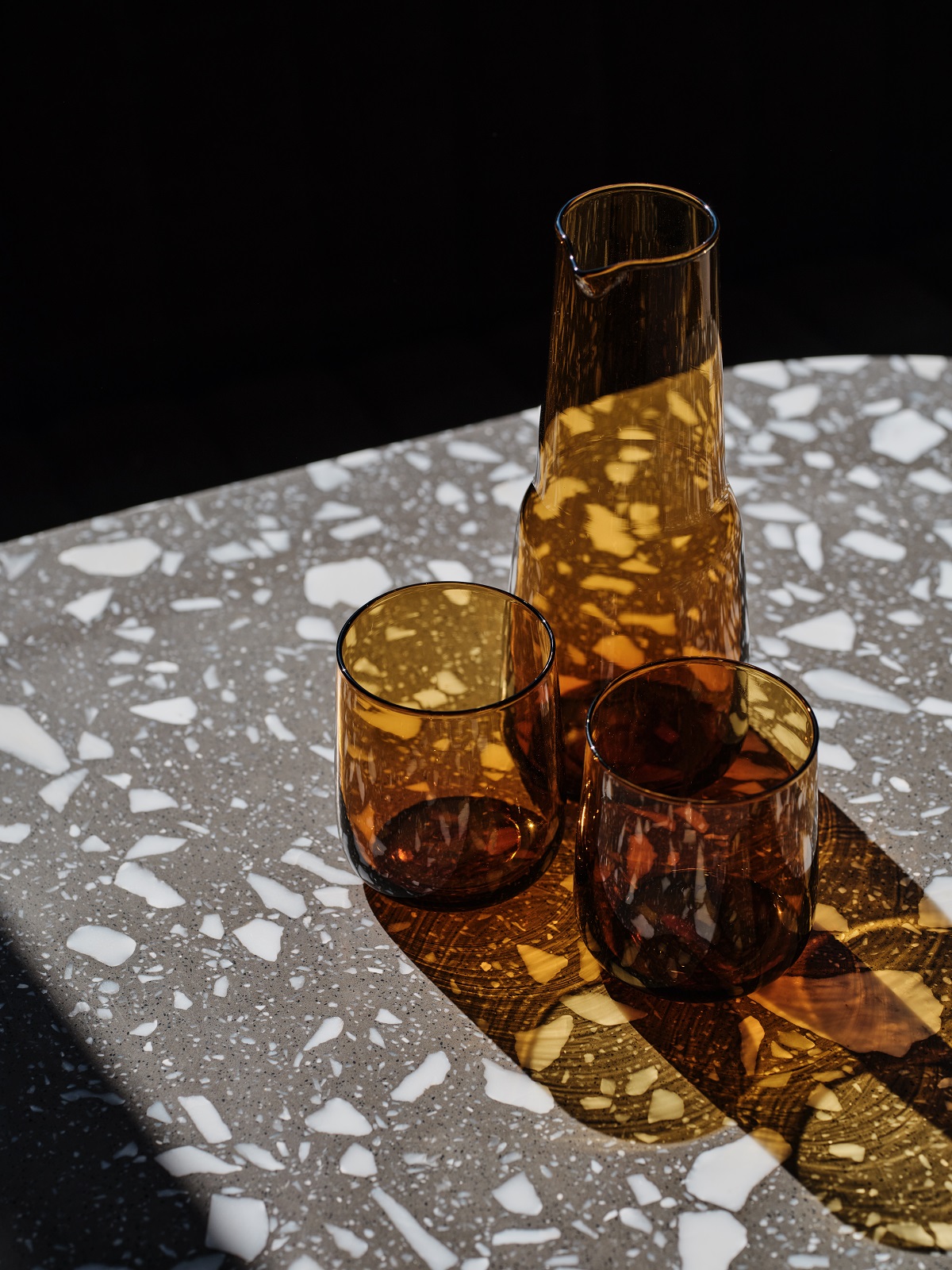 amber glass and marble table detail in hotel guestroom